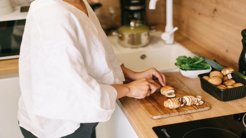 Person cutting mushrooms