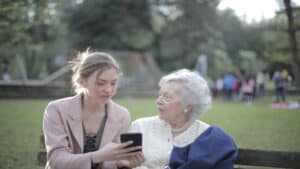 daughter teaching elderly woman